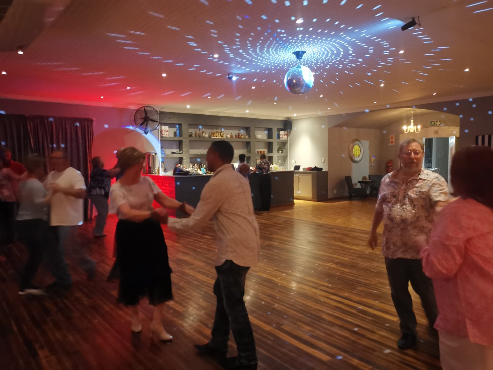 Dancing at Dancemore Dance Studio Spring Social with a mirror ball